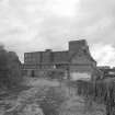 View from NNW of N side of W end of former floor maltings block, which contained barley silos.  The red saladin maltings building can be seen in the background