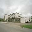 View of frontage with Bill's Bar at right from SE