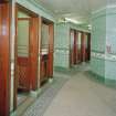 Interior. View of the two blocks of three cubicles, a further pair of cubicles being located beyond (out of picture).  All the original water closets and cisterns appear to have been removed, but most cubicles retain the green tilework.