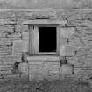 Detail of altered window at basement level of N face.