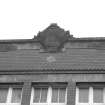 W front, roof level, cartouche containing letters: HSH, detail