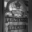 Detail of stained glass window including crown and inscription 'Royal Princess Theatre' incorporated in window design.
