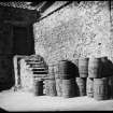 Unidentified yard with barrels. Titled 'Old Eyemouth'