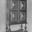 Carved cabinet with legs and painted figure decoration.