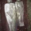 View of two carved figures, possibly Adam and Eve, Alva churchyard.