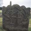 View of gravestone carved with  Memento Mori, scrolls and numeral 4, Alva churchyard.
