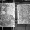 Photographic copy of two rubbings. The right rubbing shows detail of a Pictish cross slab, containing figures and an Ogam inscription. originally from Scoonie Churchyard, now held at the National Museums of Scotland. The left rubbing shows detail of the Fourdon Stone Pictish cross slab.