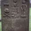 Detail of headstone to James Douglas d. 1747 showing hourglass, skull and tools, Dalry Parish Church.