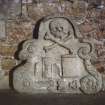 View of tomb fragment with winged hourglass, scroll, skull and skeleton, Elgin Cathedral.
