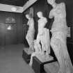 Interior view of Glasgow School of Art showing statues at E end of E corridor on ground floor.