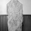 View of Kinellar Pictish symbol stone built into interior wall of church.