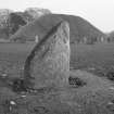 View of face of Inverurie no. 4 Pictish symbol stone and the Bass of Inverurie visible in the background.