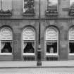 Detail of ground floor windows showing model rooms for the Edinburgh and Leith Corporations Gas Commissioners, 25 Waterloo Place, Edinburgh.