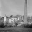 View of main building and engine house with chimneystack, Bongate Mill, Jedburgh, from south east