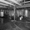 Alloa, Thistle Brewery, main building, E end, first floor, Yeast Plant, interior
View from NW showing plant. Yeast introduced into vats in Tun Room by means of buckets of yeast which were walked up the stairs between the first floor to the second floor and manually added to the fermentation tanks. This system was introduced in 1949 and superceeded the part parchute skimming system which meant that yeast was siphoned off through (a now blocked) opening in the base of the tun and into a barrow waiting on the floor below (ground floor)
