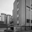 Alloa, Whins Road, Brewery
View from NW of NW end of lager maturation area with two of the ten stainless steel Dual Purpose Vessels (DPVs) behind. DPVs both ferment the wort and condition the lager/ale in the same vessel. Each vessel holds 650 barrels and were installed in 1994