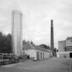 Alloa, Whins Road, Brewery
View from NNW of main switch room buildings with carbon dioxide tank behind, chimney and mill room area over brewhouse pend. The building which housed the switch gear dates from 19th-century. The carbon dioxide from the tank was used in the brewing finishing process, whereby it was used to pressurise vessels and keg containers