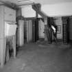 Alloa, Whins Road, Brewery, Barns Block, ground floor, interior
View of dust extractor, grain elevator (1996 - showing buckets) and part of the malt handling system. The dust from the grain is drawn by a vacuum through the extractor into 'socks' whose contents are then emptied into collection bags for disposal



