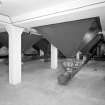 Alloa, Whins Road, Brewery, Barns Block, basement floor, interior
View of bottom of the nine 45 tonne grain silos. Bulk grain was stored here until a mix is required by the mill room. The correct ratio of chocolate, crystal and bulk are mixed and sent to the weigh hopper (or bin 'E') on the top floor