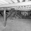 Alloa, Whins Road, Brewery, Barns Block, fourth floor, interior
View of top of the malt bins and grain silos. The intake conveyor is visible in the background. The four malt bin shutes are on the right. The intakes to the nine silos are partially visible on the left. Bin 'E' (where the mix of crystal, chocolate and bulk malt is mixed) is also situated on third/fourth floors