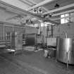 Alloa, Whins Road, Brewery, Wort Cooling area, interior
View of two stainless steel paraflow or heat exchangers which can deal with some 135 barrels per hour. After the wort is pumped from the whirlpool it is cooled, using chilled liquor, from boiling point to about 10-16 degrees centigrade (depending on the brew) in about 2 hours. The cooled wort is then be transferred to the fermentation area. Other stainless steel vessels on the right are used in the routing of detergents around the brewery (not in situ)