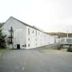 Islay, Caol Ila Distillery.
View of distillery from SSE, with bonded warehouse occupying the S end of the distillery complex in the foreground