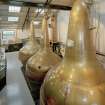 Bowmore Distillery
Interior view within still house showing three of the four copper pot stills, all of which are heated by steam coils