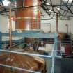 Bowmore Distillery
Interior view within mash house showing mash tun (below), grist hopper (above), and copper water tanks in background