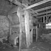 Detail of threshing machine in barn.