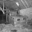 Detail of threshing machine in barn.