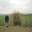 View of standing stone; Mr Adam Welfare (RCAHMS) in picture
