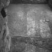 Excavation photograph : floor level within basement of tower house showing outlines of modern drains running N-S and cut for stair plinth in foreground.