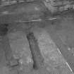 Excavation photograph : NE end of floor of tower house basement showing partially excavated, from SW.