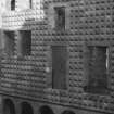 Excavation photograph : part of Italianate facade of N range showing nail head decoration.