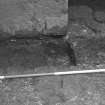 Excavation photograph : close up of partially excavated foundation cut for S wall of N range, from S.