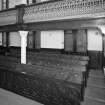 Interior. Pews and gallery column detail
