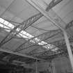 Interior view of workshops showing detail of wooden roof trusses