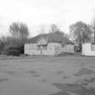 General exterior view of derelict timber building.