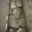 View of paving at N end of the excavation trench. Scale in 200mm divisions