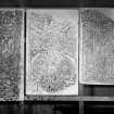Photographic copy of three rubbings. The left rubbing shows detail of a cross-shaft fragment, originally from Closeburn Parish Church, now held at Dr Grierson's Museum, Thornhill.
The central and right rubbings show details from the upper and lower fragments of the face of a cross slab, originally found in Rothesay Castle being used as the foot of a stair, now held at Bute Museum.