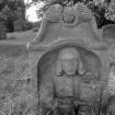 View of headstone commemorating Horsburgh (died 1735) with portrait of man holding book.