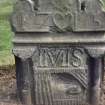 View of headstone dated 1715 with initials IMIS showing rose, heart and death scene, Strathmiglo Parish Churchyard.