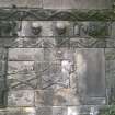 View of wall monument with carved heads, figures and possible gravediggers tools, Inverness Chapel Yard cemetery.