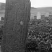 Skye, Glen Dale, St Comgan's Chapel. View of late medieval graveslab, reused as headstone and set inverted in ground.