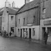 View of 9-17 High Street, Thurso, from south west showing the end of no. 9, W D Murray bicycle shop, MacKay's Stores and R Fidler shop.
