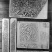 Photographic copy of five rubbings. The middle right rubbing shows details of a cross slab in St Serf's Church, Dunning and the remaining rubbings shows details of a cross slab from Rothesay Castle, now in Bute Museum.