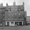 General view of the front facade of 104 St Leonard's Street, Edinburgh, including Castle o' Clouts, from SW and part of the Usher Brewery.