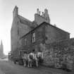 View of the side of 104 St Leonard's Street, Edinburgh including Castle o' Clouts seen from the entrance lane to Usher Brewery from NE, showing horse-drawn cart.