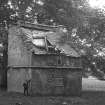 View of the dovecot at Kailzie House from SW, with a boy beside it and photography equipment in the foreground.