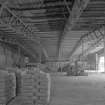 Interior view from SW across lime store (a former aircraft hangar), revealing its latticed steel frame